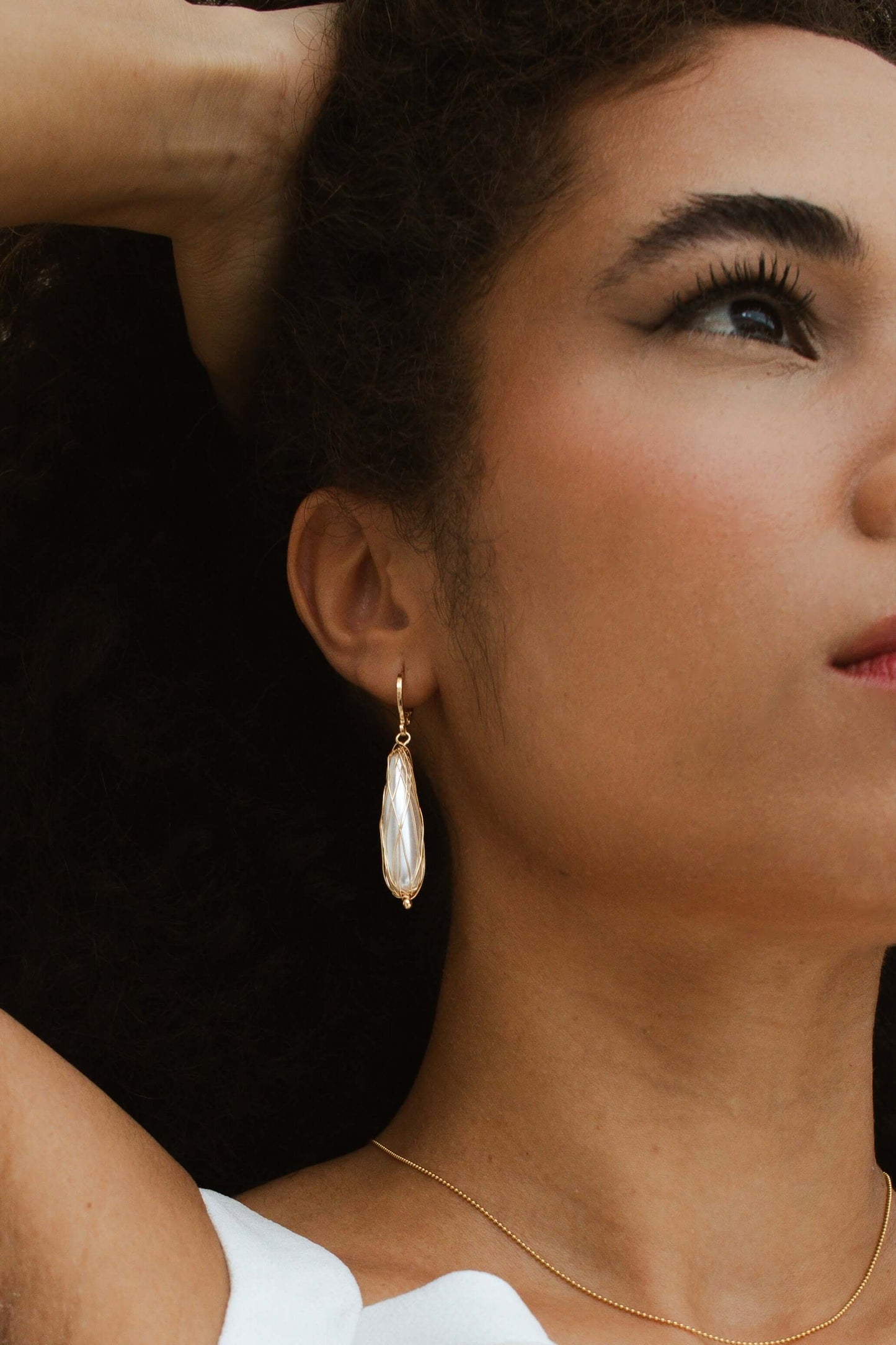 Model wearing Velani Jewelry Pearl Chandelier Earrings, 18K gold filled, hypoallergenic, waterproof, elegant for everyday wear.