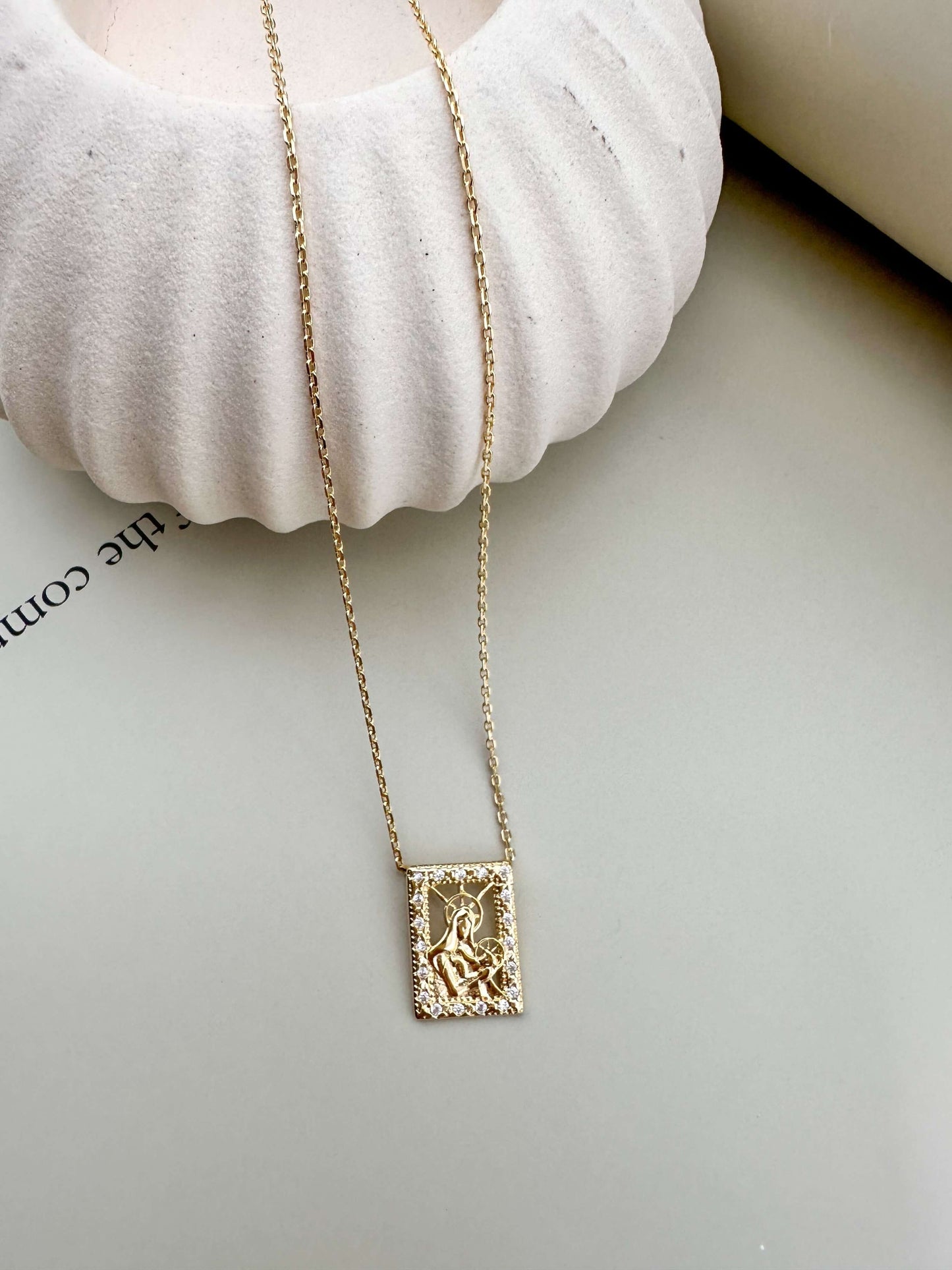 Gold filled Madonna and Child necklace with intricate design, hypoallergenic, waterproof, perfect for everyday wear.