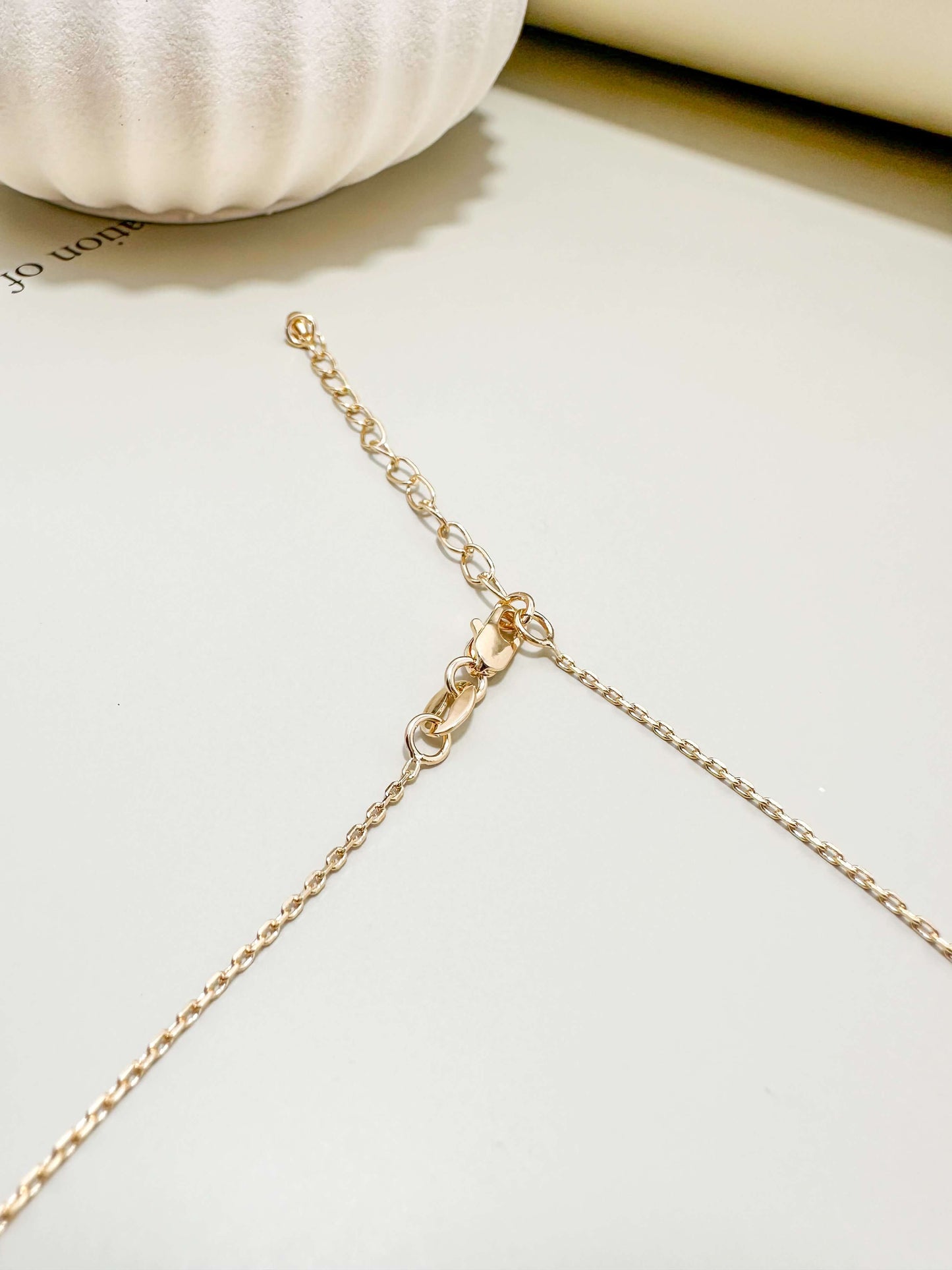 Close-up of Velani Jewelry's 18K gold filled lobster clasp, highlighting its hypoallergenic and tarnish-resistant features.