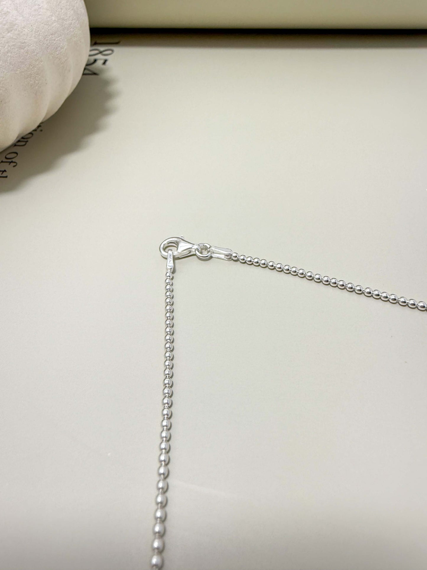 Close-up of Velani Jewelry sterling silver bead necklace clasp, showcasing the quality and design.