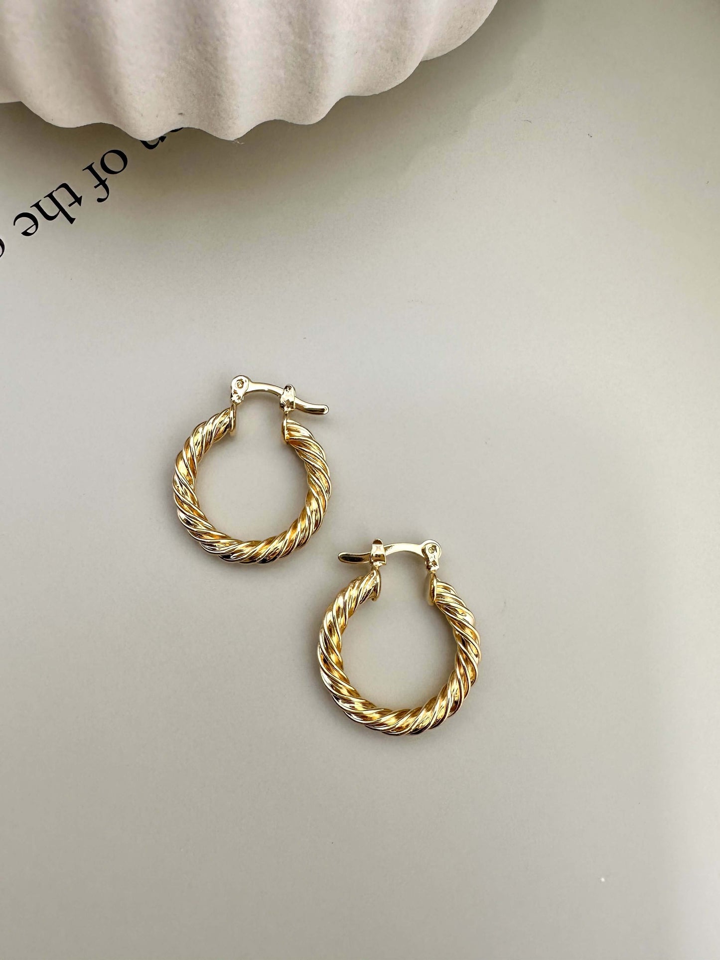 Velani Jewelry Twisted Hoop Earrings in 18K Gold Filled, hypoallergenic, waterproof, tarnish resistant, ideal for everyday wear.