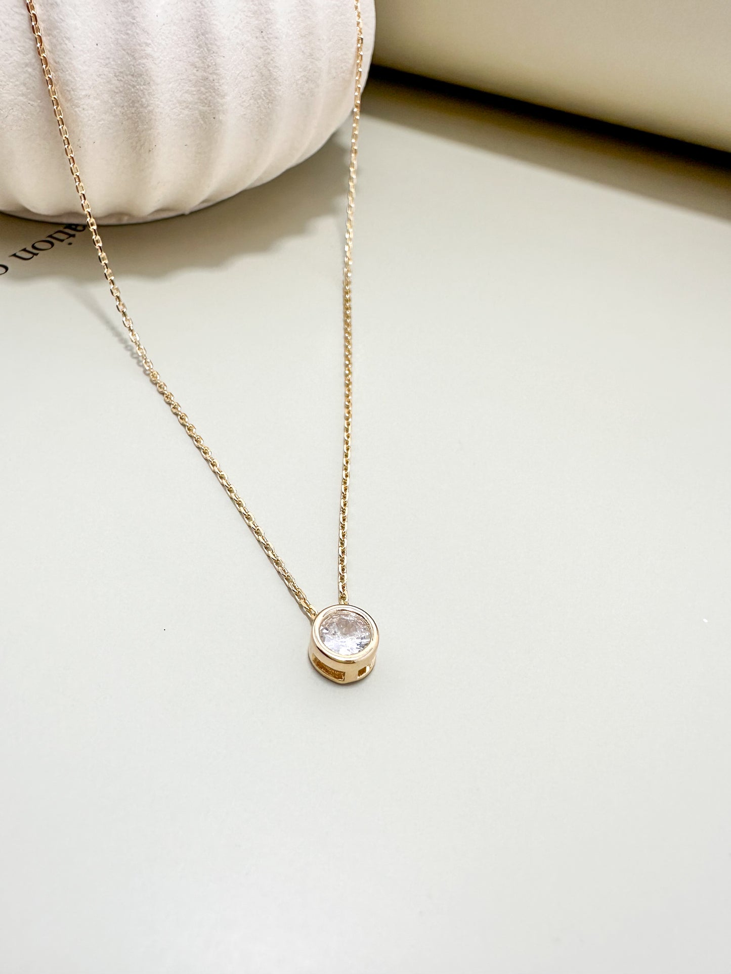 Velani Jewelry 18K Gold Filled Solitaire Diamond Necklace on a soft background, featuring a high-quality CZ pendant.