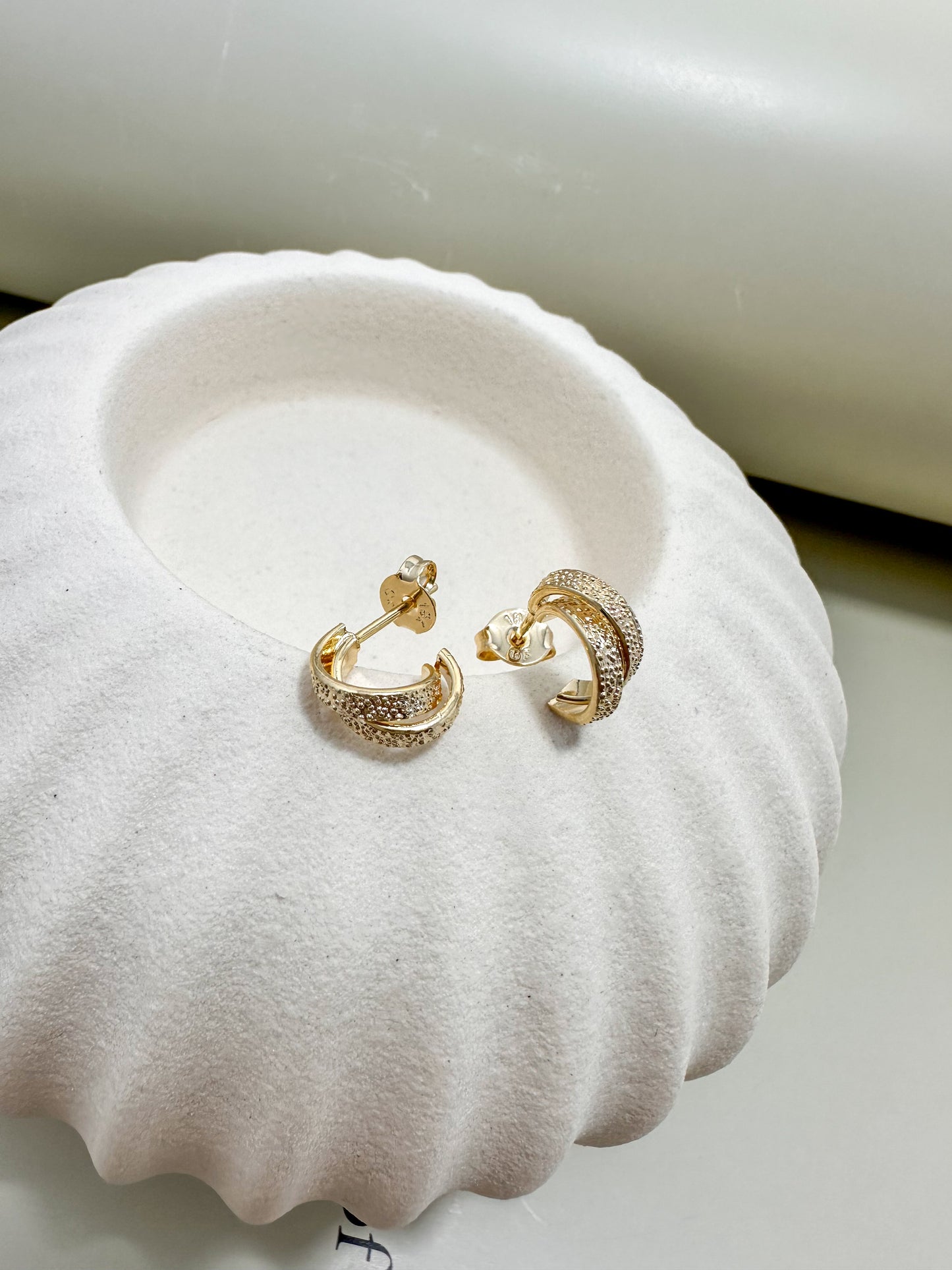 Velani Jewelry Mini Dainty Double C Hoop Earrings displayed on a shell-shaped jewelry holder.