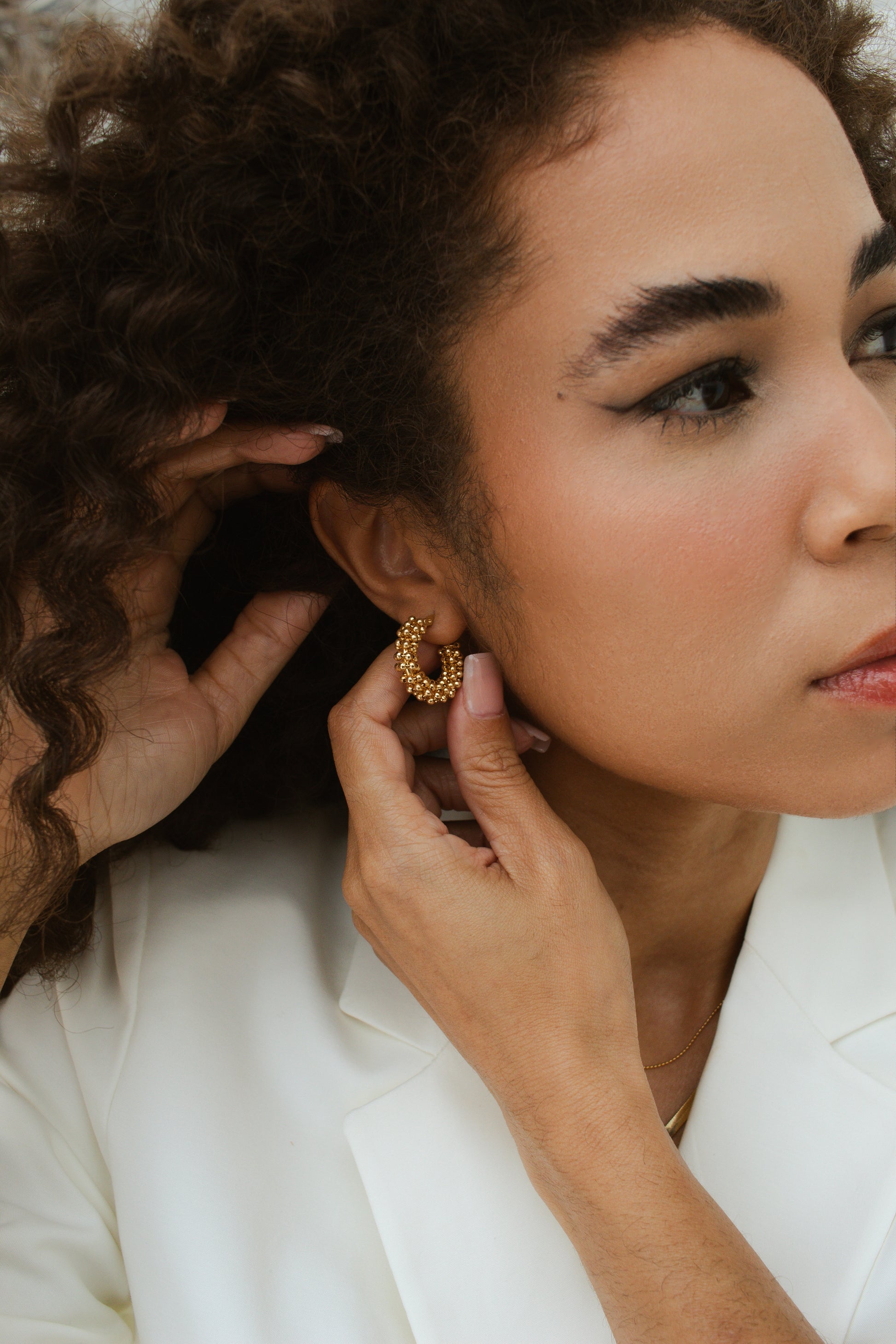 Woman wearing Velani Jewelry Beads Cluster Hoop Earrings, 18K gold filled, handcrafted in Brazil, hypoallergenic.