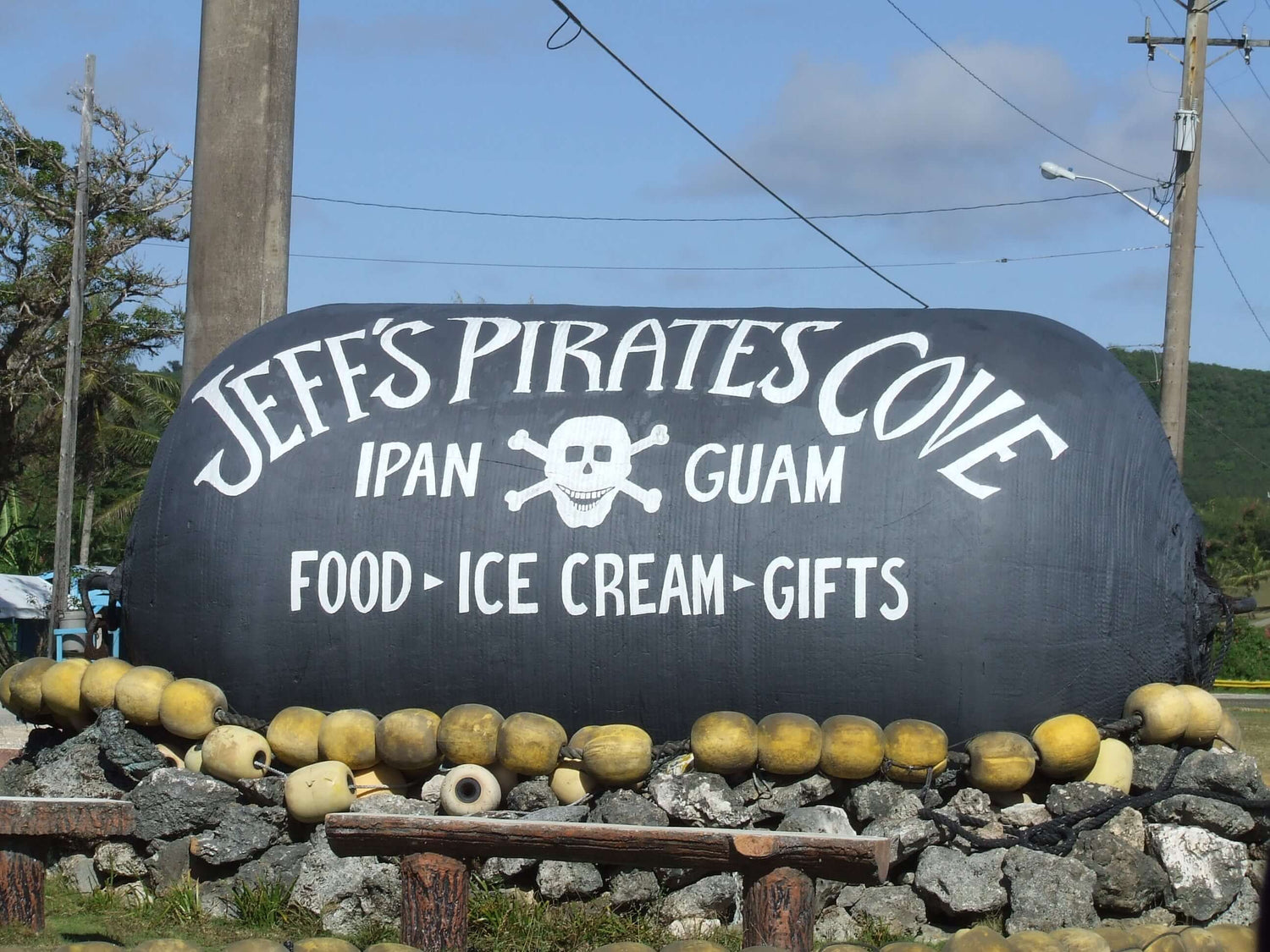 "Entrance sign at Jeff's Pirates Cove in Ipan Talofofo Guam, featuring food, ice cream, and gifts"