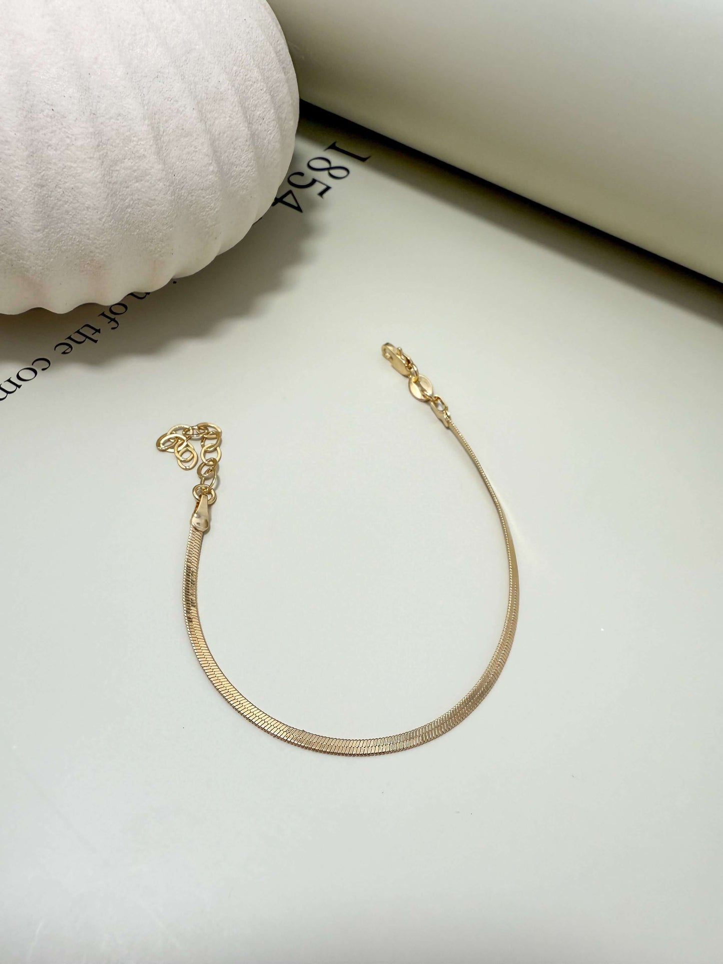 Velani Jewelry 2mm Herringbone Bracelet in 18K gold filled, waterproof, hypoallergenic, tarnish resistant, perfect for everyday wear.