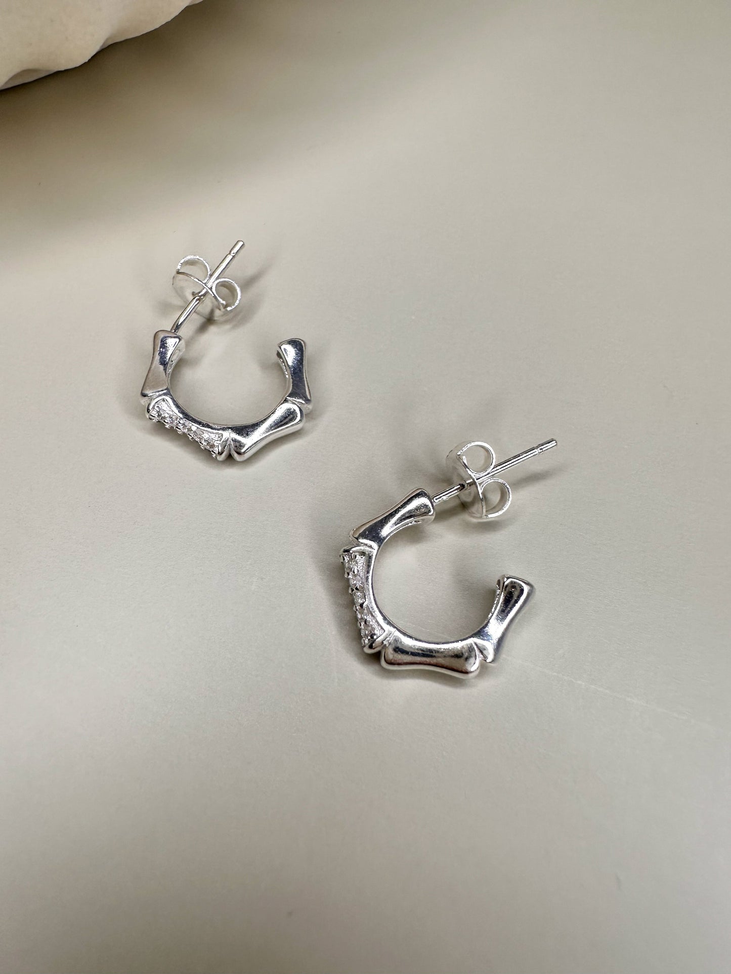 Velani Jewelry Bamboo Half Hoop Earrings in Sterling Silver with CZ stones, handcrafted in Brazil, nickel-free and waterproof.