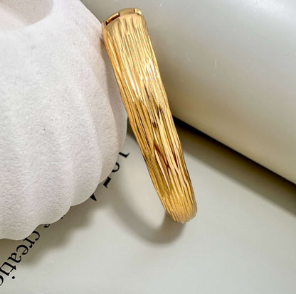 Velani Jewelry brushed bangle bracelet, hypoallergenic, gold plated, tarnish resistant, durable for everyday wear.
