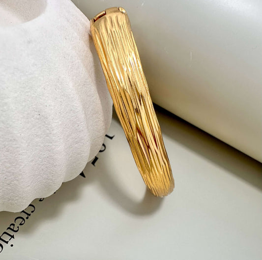 Velani Jewelry brushed bangle bracelet, hypoallergenic, gold plated, tarnish resistant, durable for everyday wear.