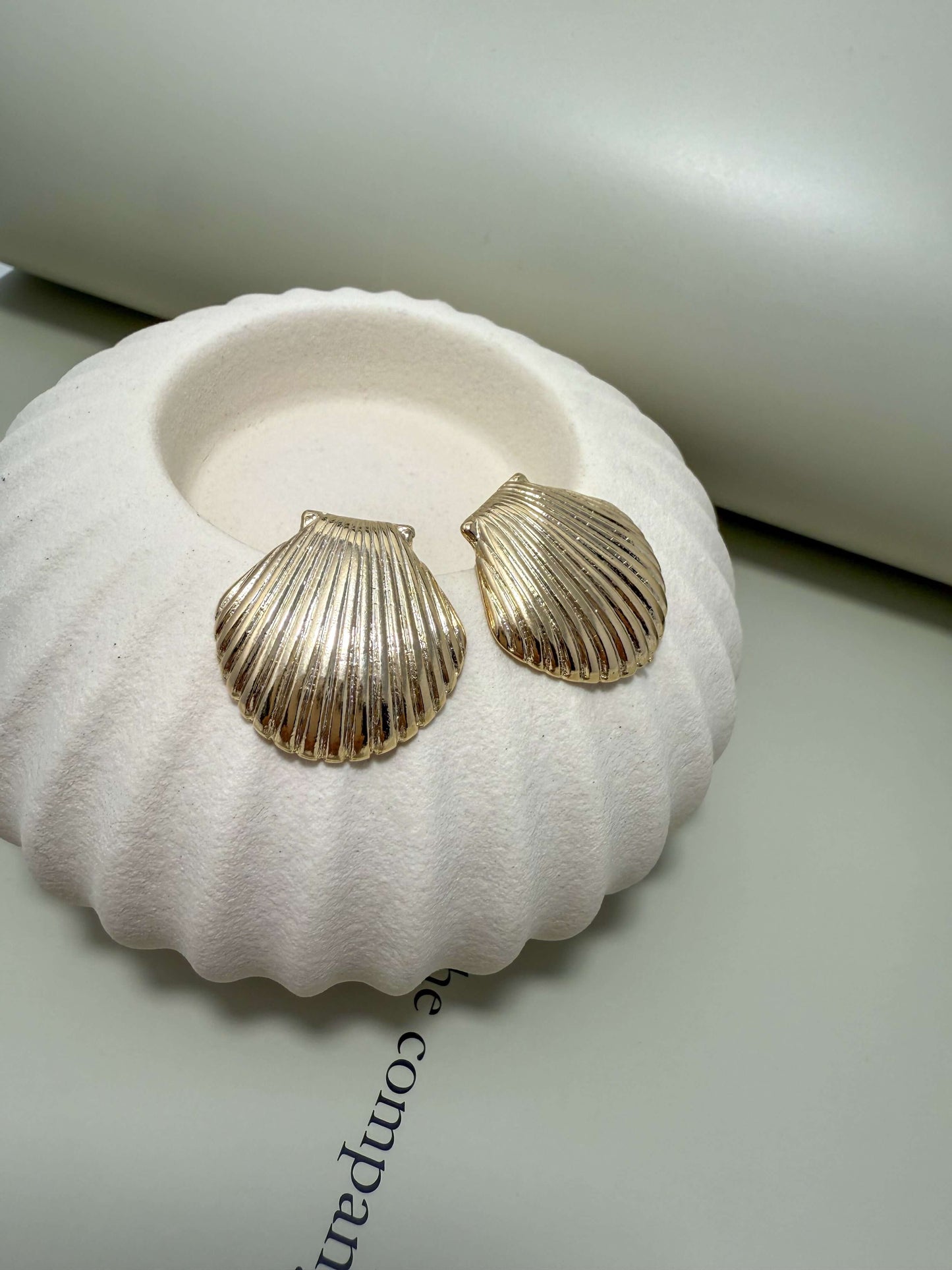 Elegant Velani Jewelry clam shell stud earrings in 18K gold filled, hypoallergenic, waterproof, and tarnish resistant for everyday wear.