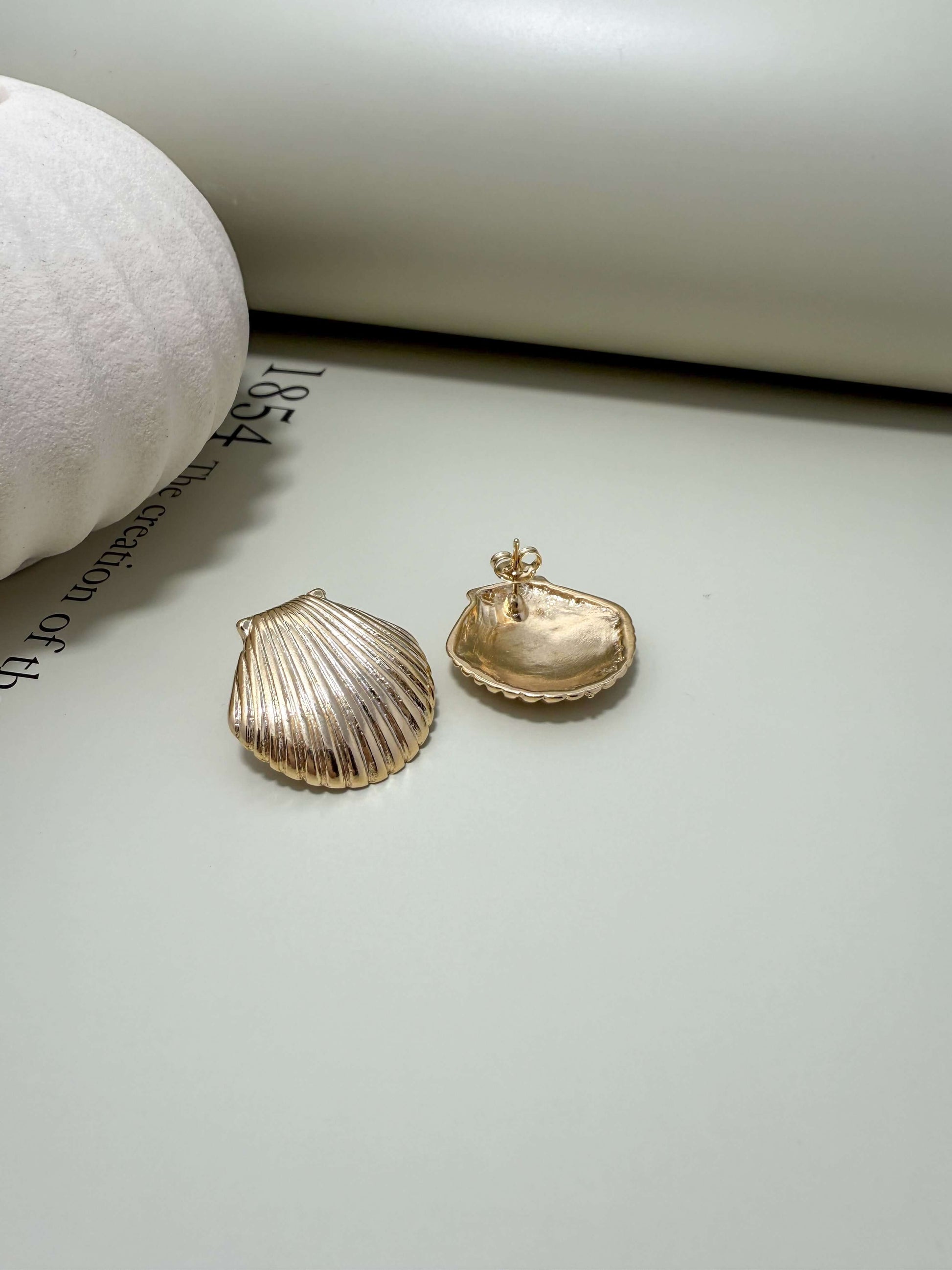 Velani Jewelry Clam Shell Stud Earrings in 18K gold filled, hypoallergenic, waterproof, tarnish resistant for everyday wear.