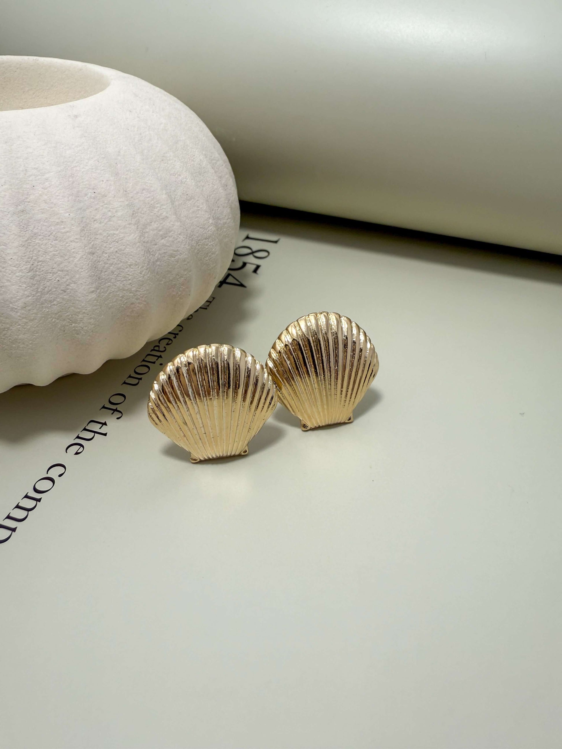 Velani Jewelry clam shell stud earrings, 18K gold filled, hypoallergenic, tarnish resistant, waterproof for everyday wear.