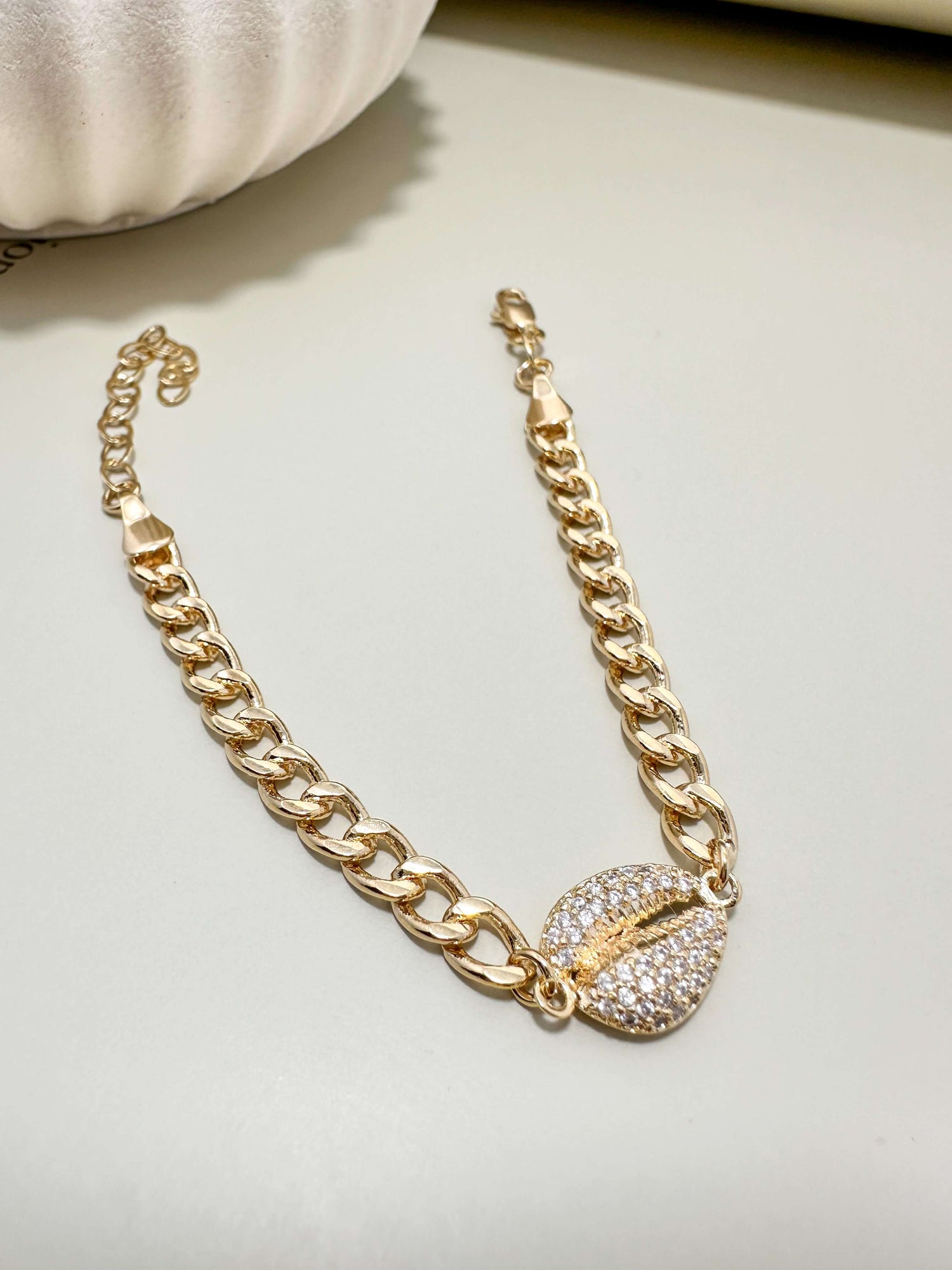 Velani Jewelry Cowrie Cuban Bracelet in gold filled with cubic zirconia, hypoallergenic and waterproof for everyday wear.