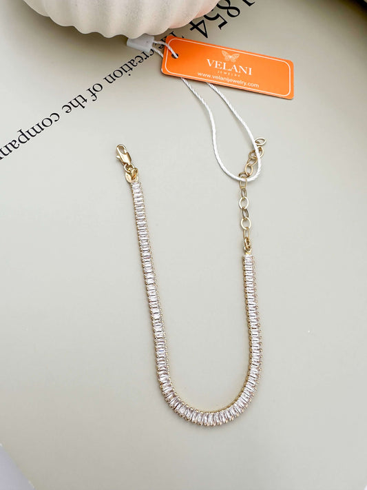 Dainty Velani Jewelry baguette CZ bracelet, 18K gold filled, hypoallergenic, waterproof, tarnish resistant, ideal for everyday wear.