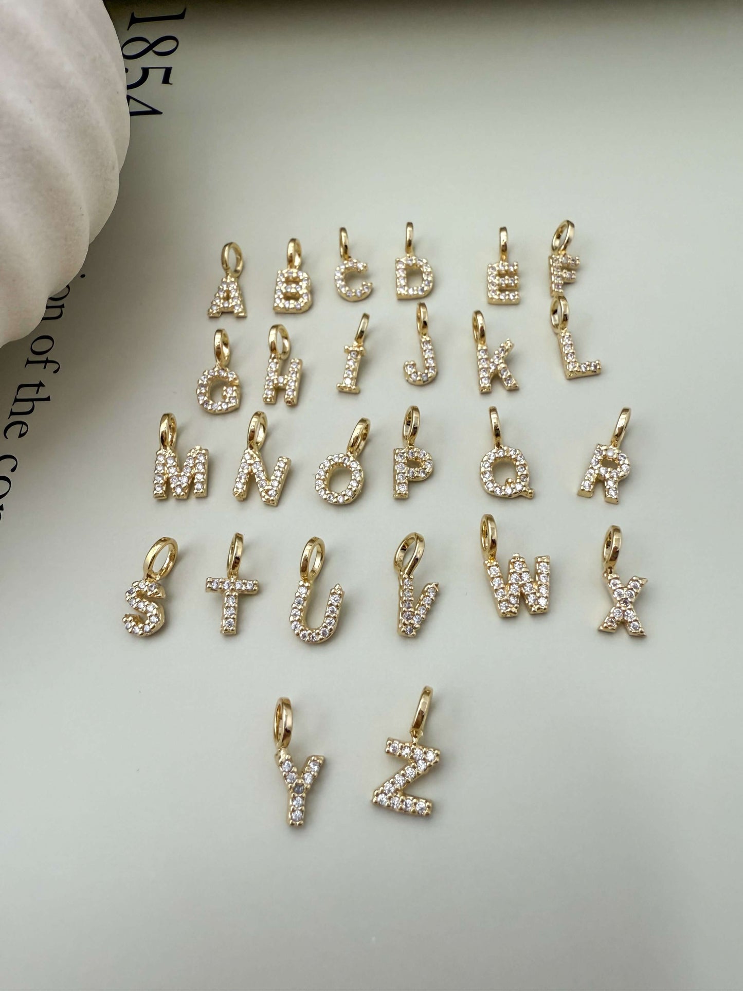 Dainty gold filled initial letter pendants with cubic zirconia, hypoallergenic and tarnish resistant jewelry.