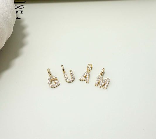 Dainty initial letter pendants in 18K gold filled with CZ, hypoallergenic and tarnish resistant, perfect for everyday wear.