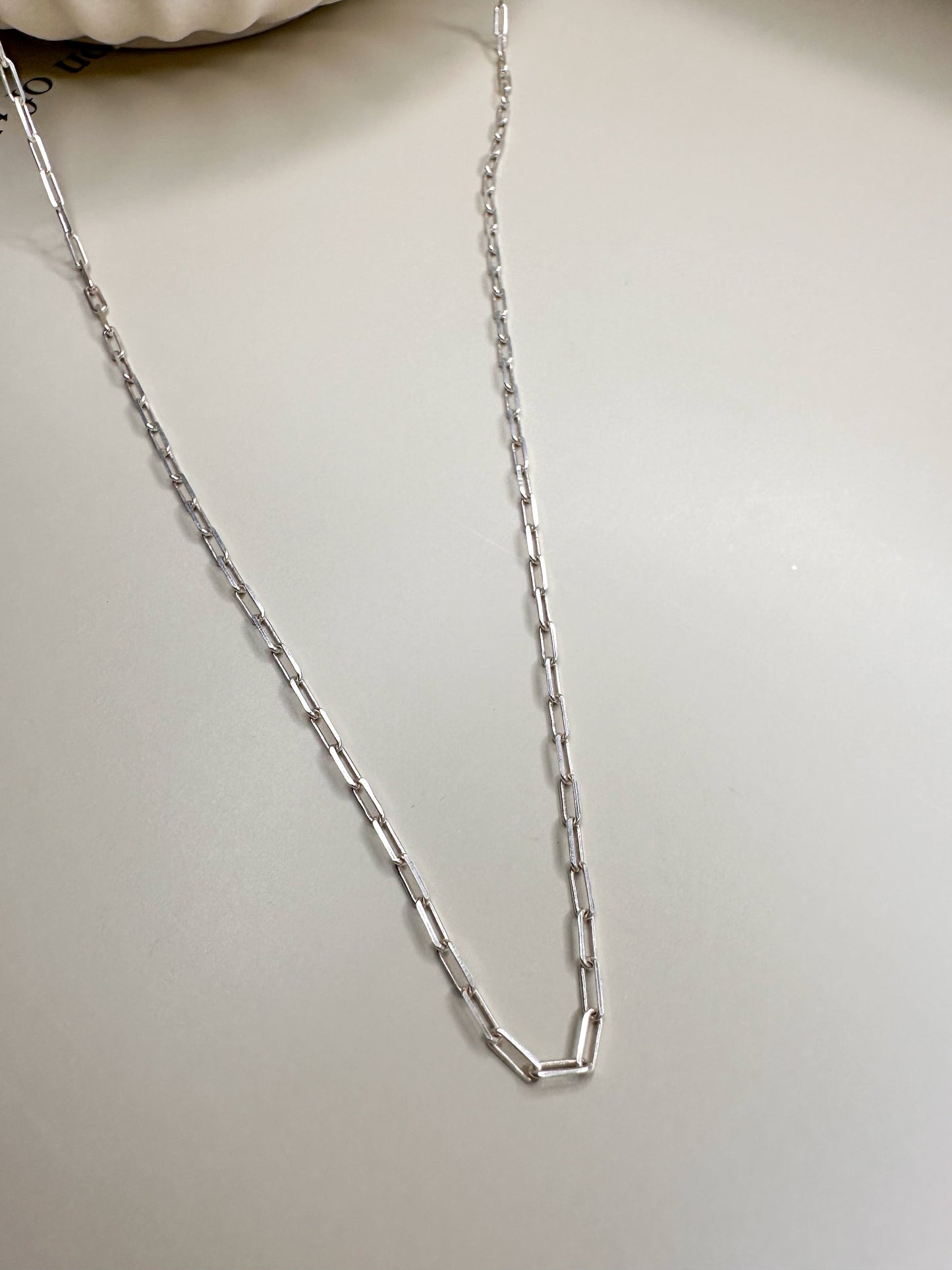 Velani Jewelry Dainty Paperclip Necklace in Sterling Silver, 18-inch, nickel-free, handcrafted in Brazil, displayed on a white background.