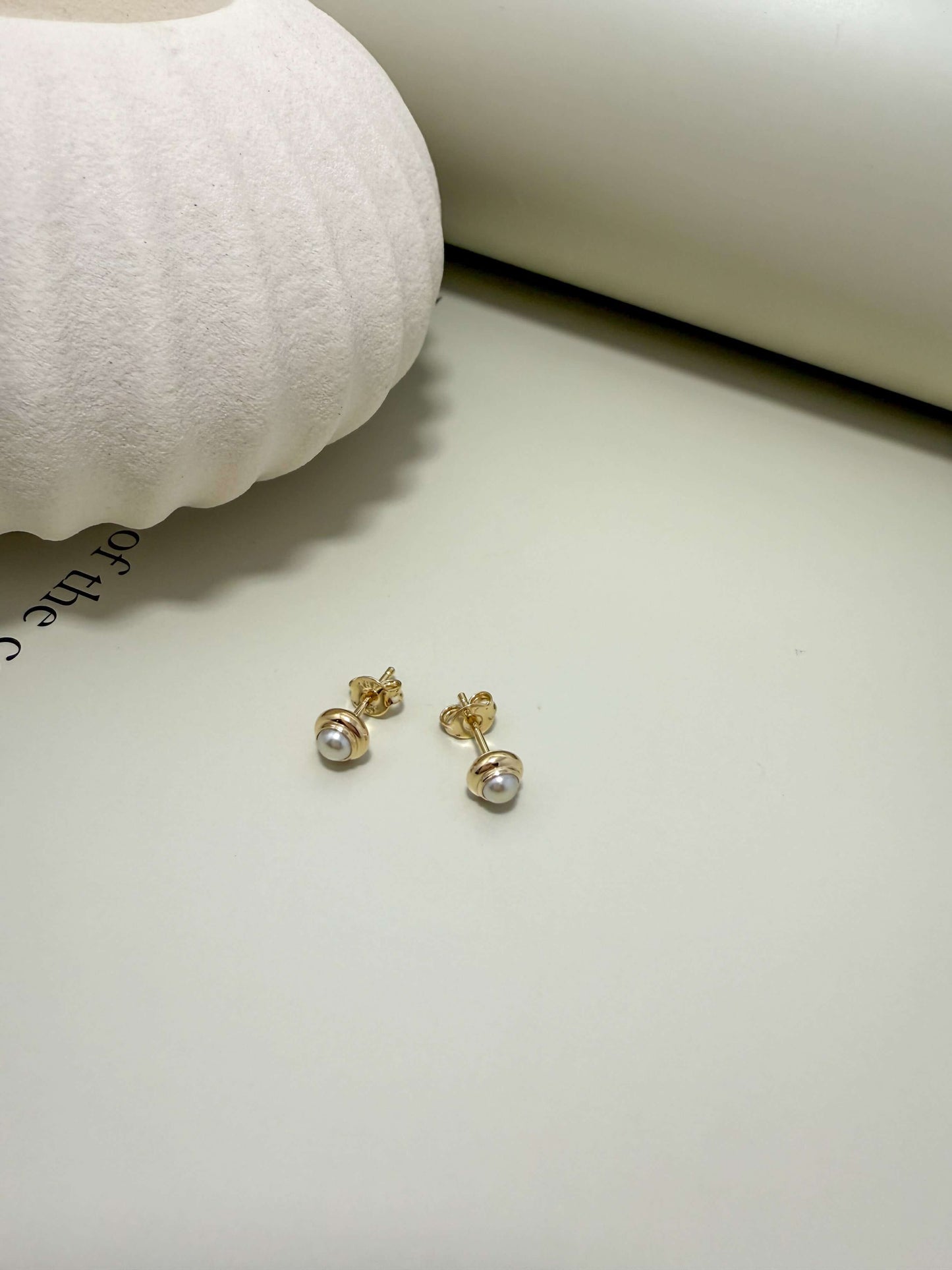 Dainty pearl stud earrings in 18K gold filled setting. Hypoallergenic, waterproof, tarnish resistant for everyday wear.