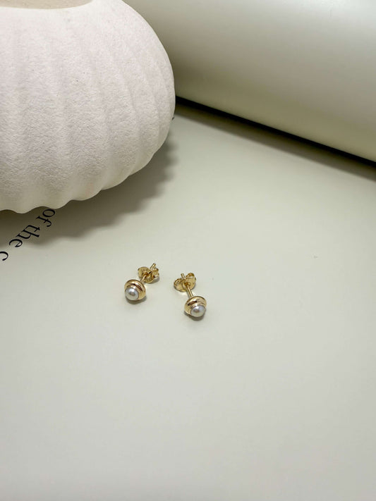 Dainty pearl stud earrings in 18K gold filled setting. Hypoallergenic, waterproof, tarnish resistant for everyday wear.