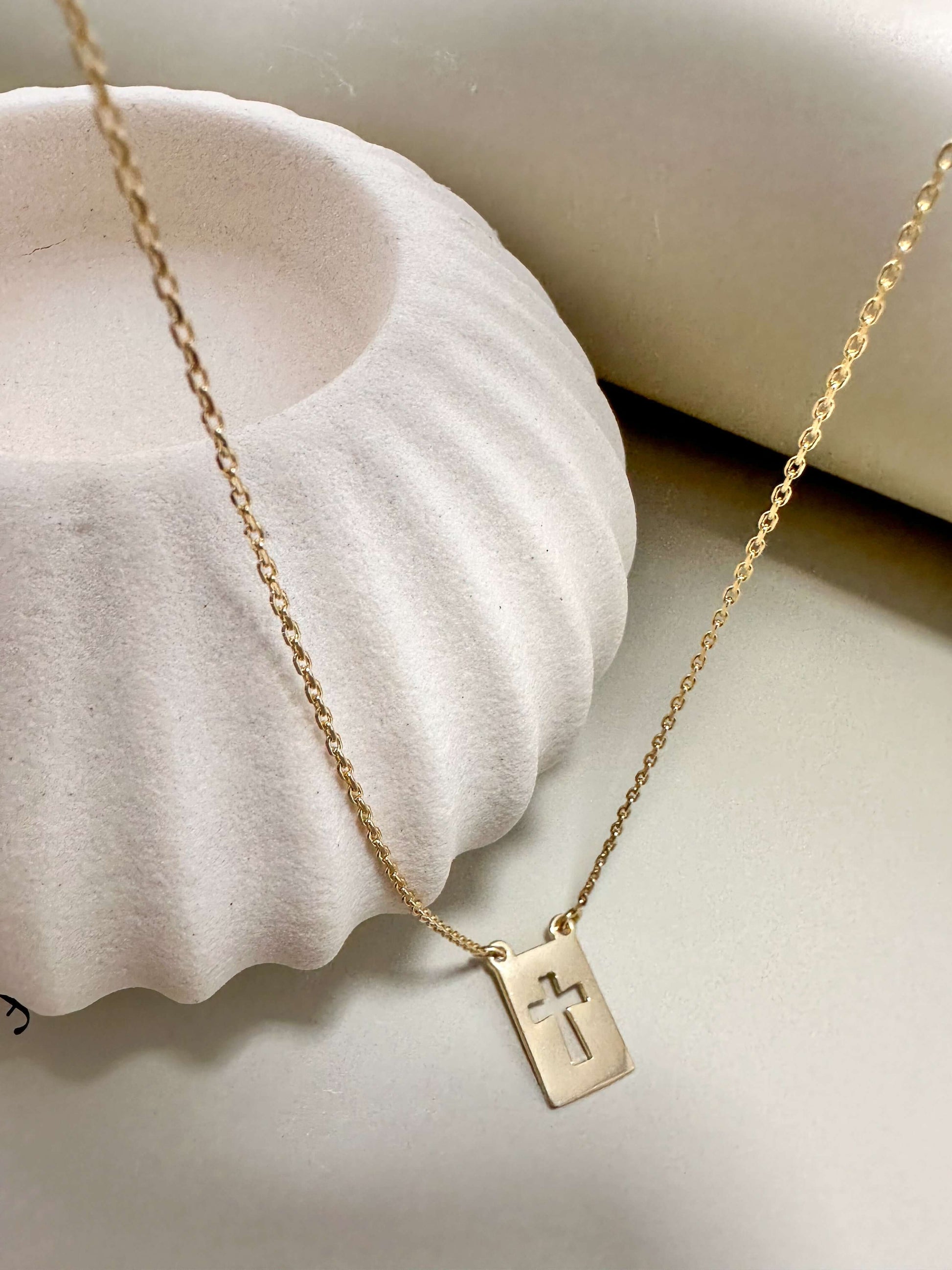 Dainty Velani Jewelry El Shaddai Cross Plaque Necklace in gold, hypoallergenic and waterproof, ideal for everyday wear.