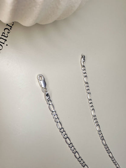 Sterling silver Figaro anklet from Velani Jewelry, handcrafted in Brazil, featuring durable waterproof design.