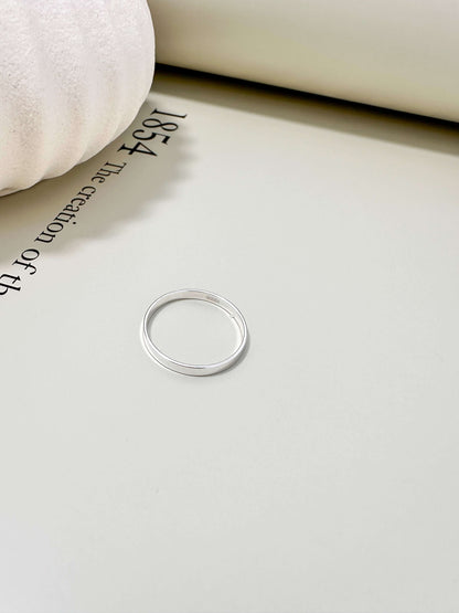 14K gold filled and hypoallergenic flat band ring on a soft surface, tarnish resistant and waterproof for everyday wear.