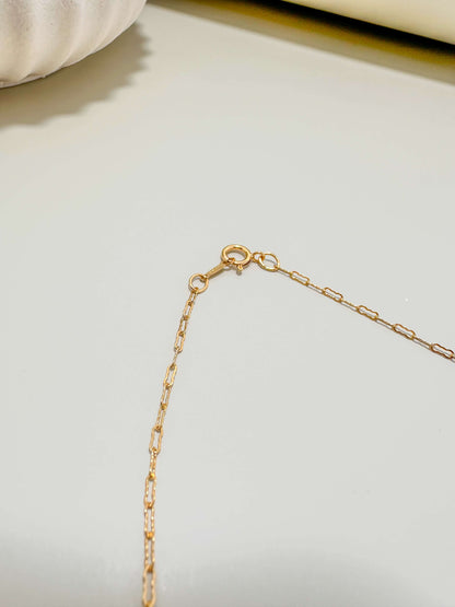 Close-up of the clasp on a Velani Jewelry gold filled flat krinkle necklace, showcasing its tarnish resistant and waterproof design.