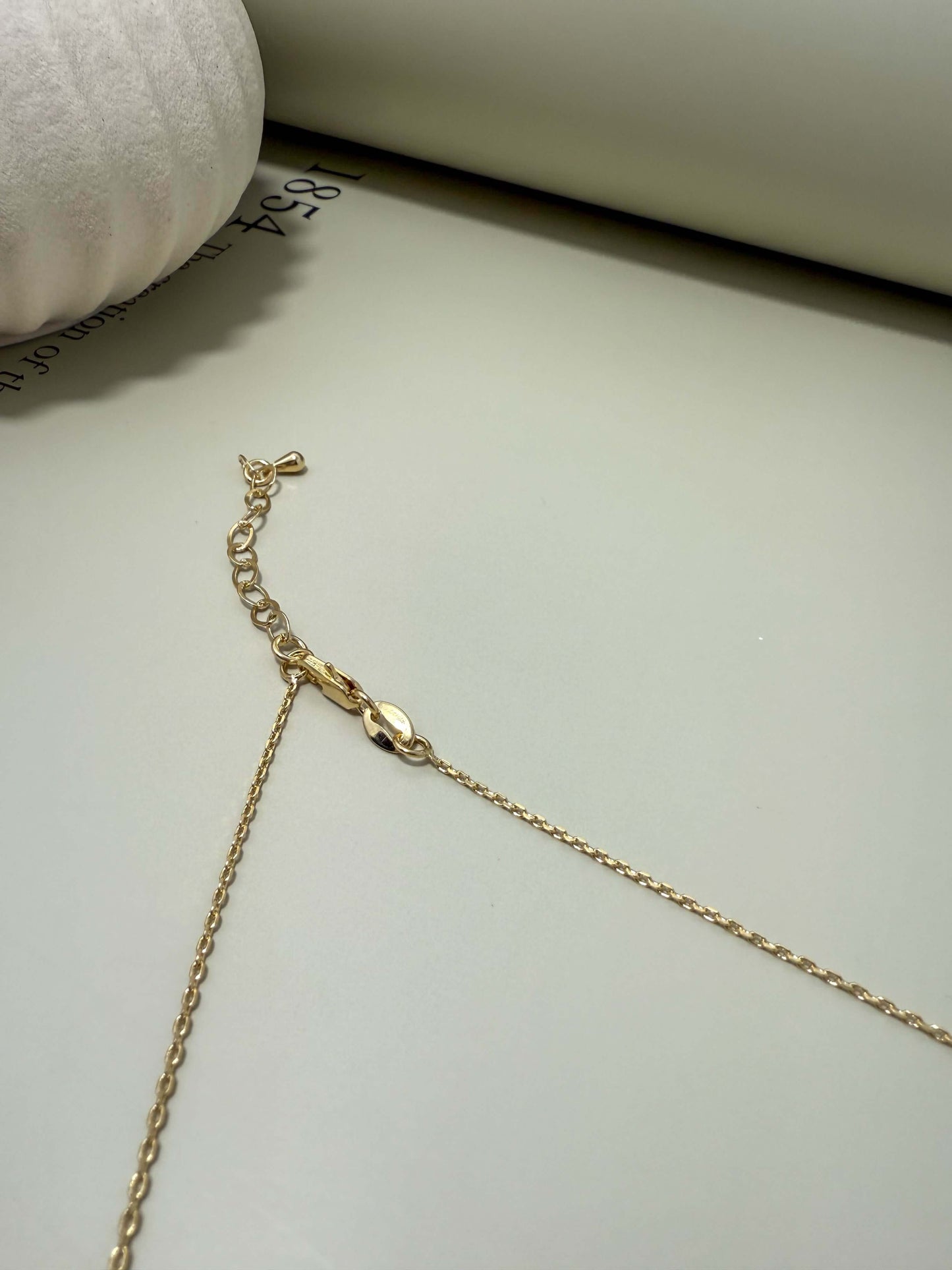 Close-up of Velani Jewelry La Cross Necklace clasp, showcasing its gold filled, tarnish resistant chain and hypoallergenic features.