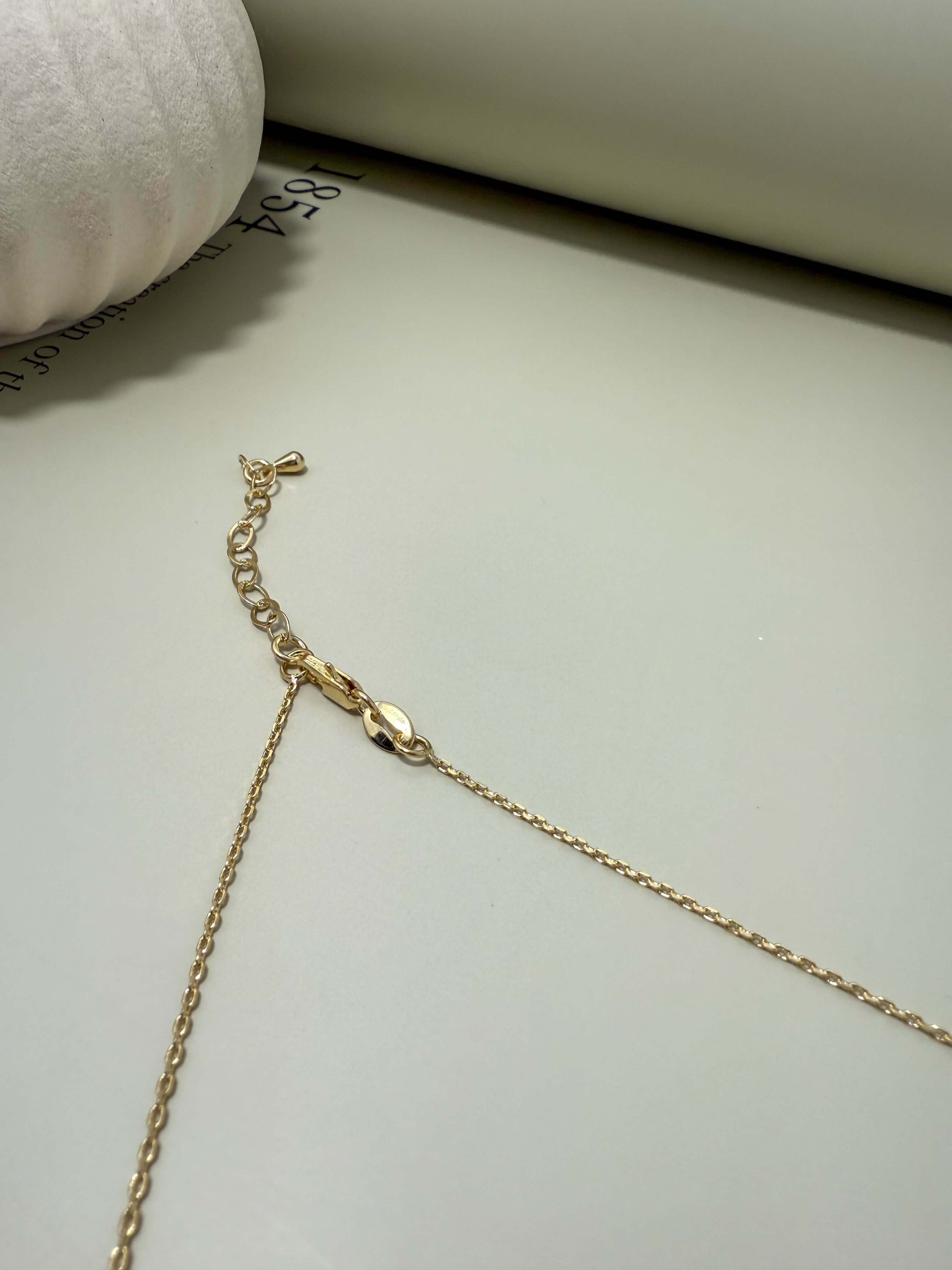 Close-up of Velani Jewelry La Cross Necklace clasp, showcasing its gold filled, tarnish resistant chain and hypoallergenic features.