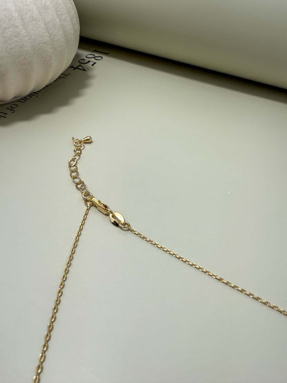 Close-up of Velani Jewelry La Cross Necklace clasp, showcasing its gold filled, tarnish resistant chain and hypoallergenic features.