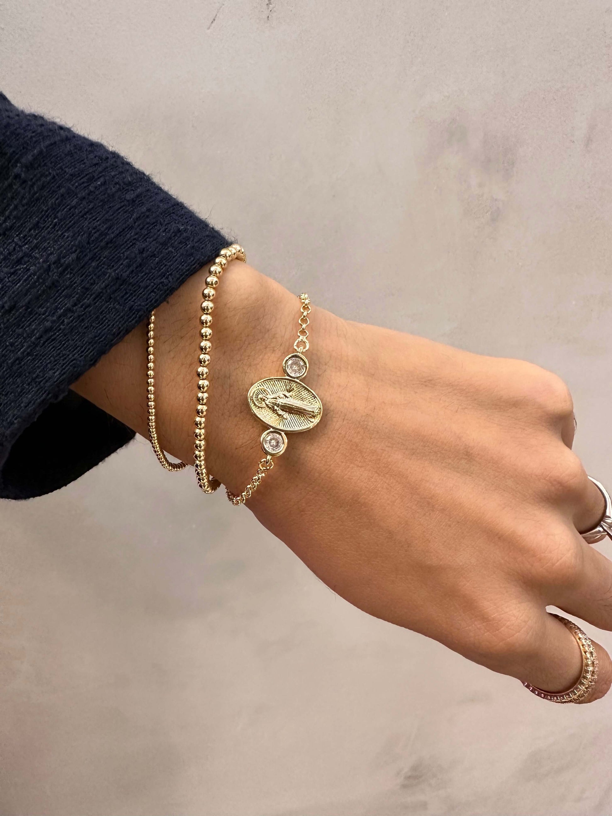 Hand wearing Velani Jewelry Lady of Grace Bracelet, featuring gold filled chain and cubic zirconias, perfect for everyday wear.