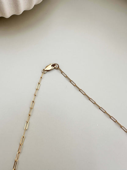 Close-up of Velani Jewelry lunar paperclip necklace chain clasp, 14K gold filled, hypoallergenic and tarnish resistant.