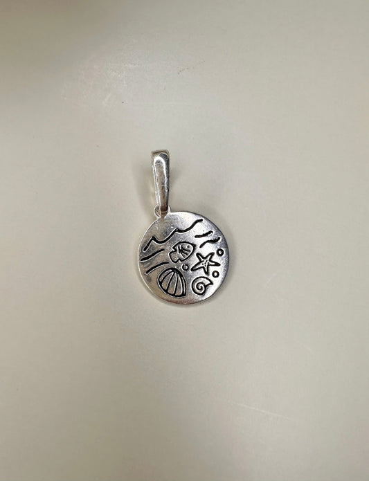 Velani Jewelry Oceans Medallion in Sterling Silver, featuring ocean motifs, 10mm, nickel-free and waterproof, handcrafted in Brazil.