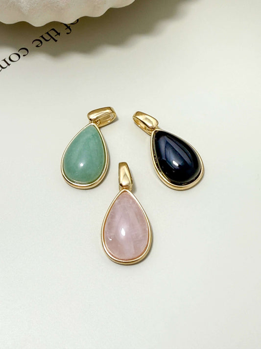 Gold filled teardrop pendants featuring green quartz, rose quartz, and black stone, hypoallergenic and waterproof.