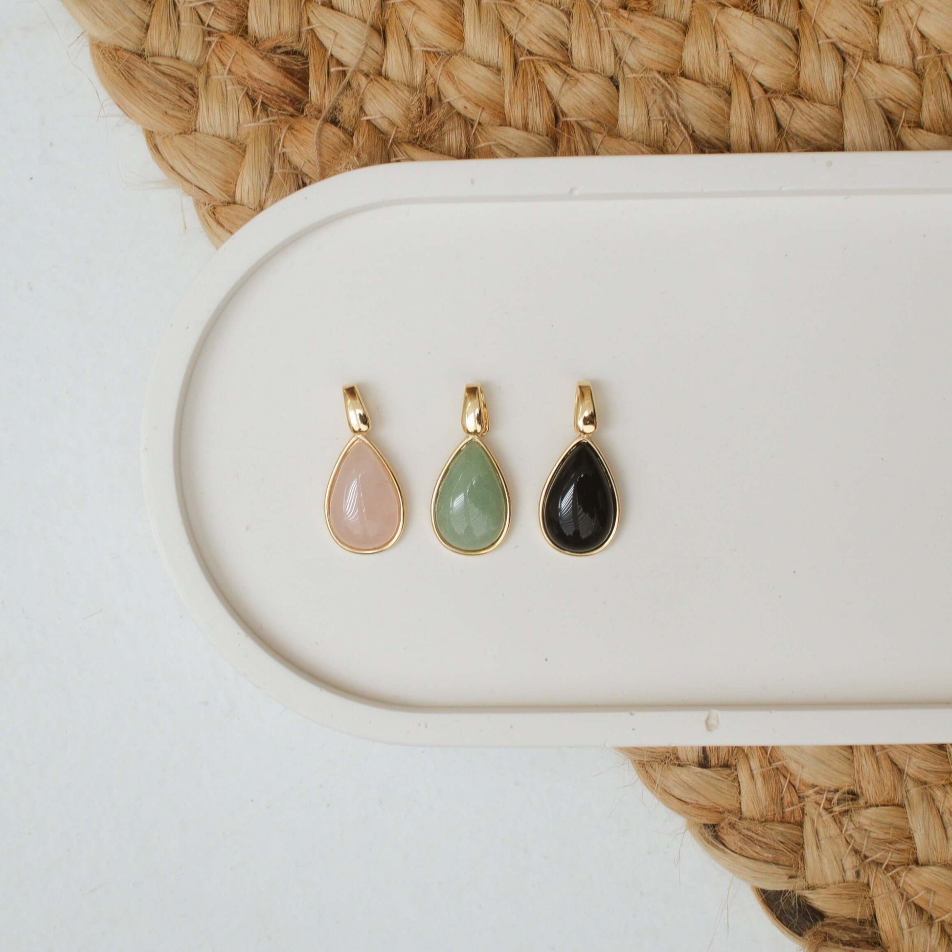 Teardrop pendants in gold filled settings featuring semiprecious stones: pink, green, and black for everyday wear.