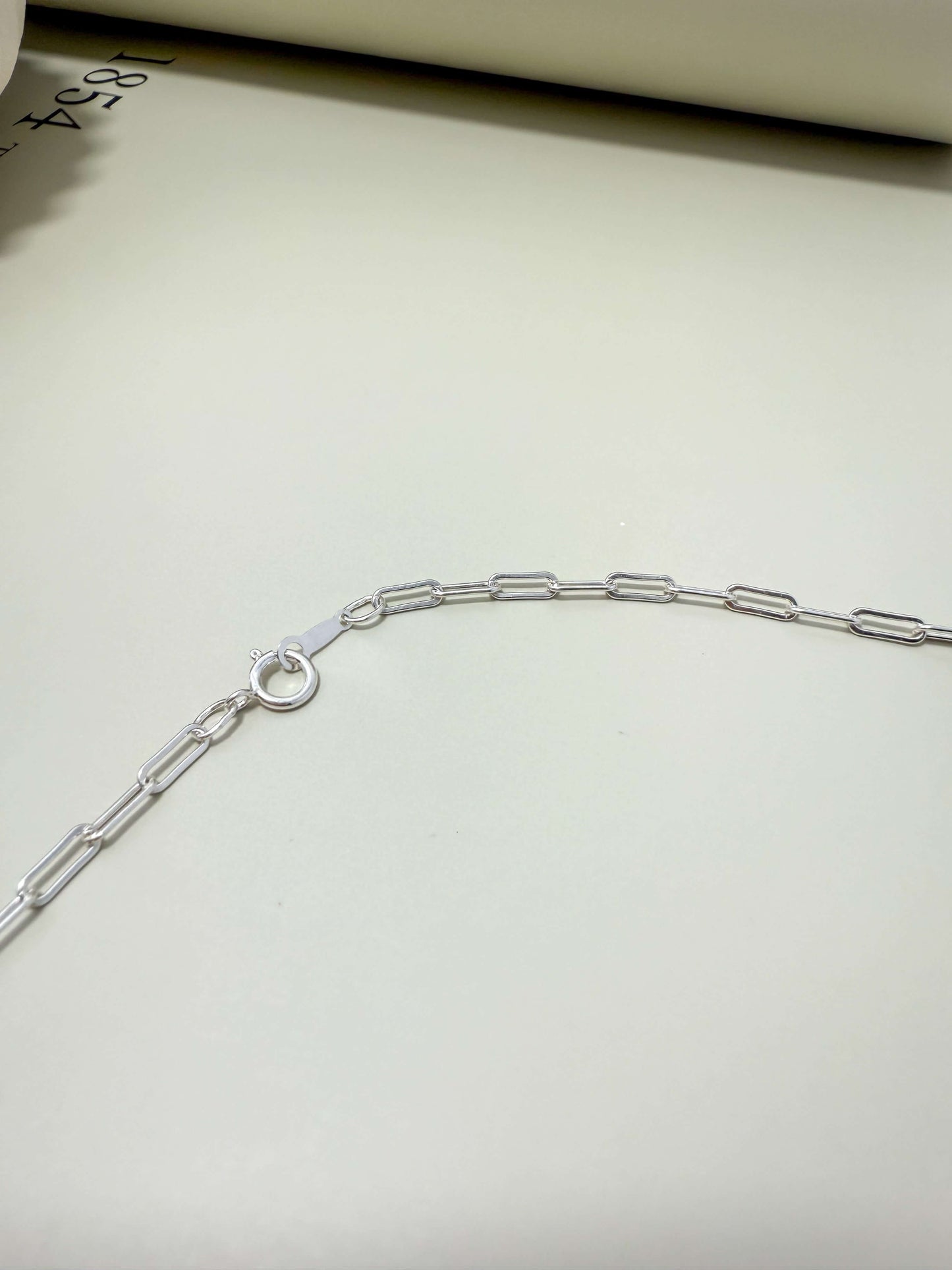 Sterling silver flat paperclip chain by Velani Jewelry. Hypoallergenic, waterproof, tarnish resistant for everyday wear.