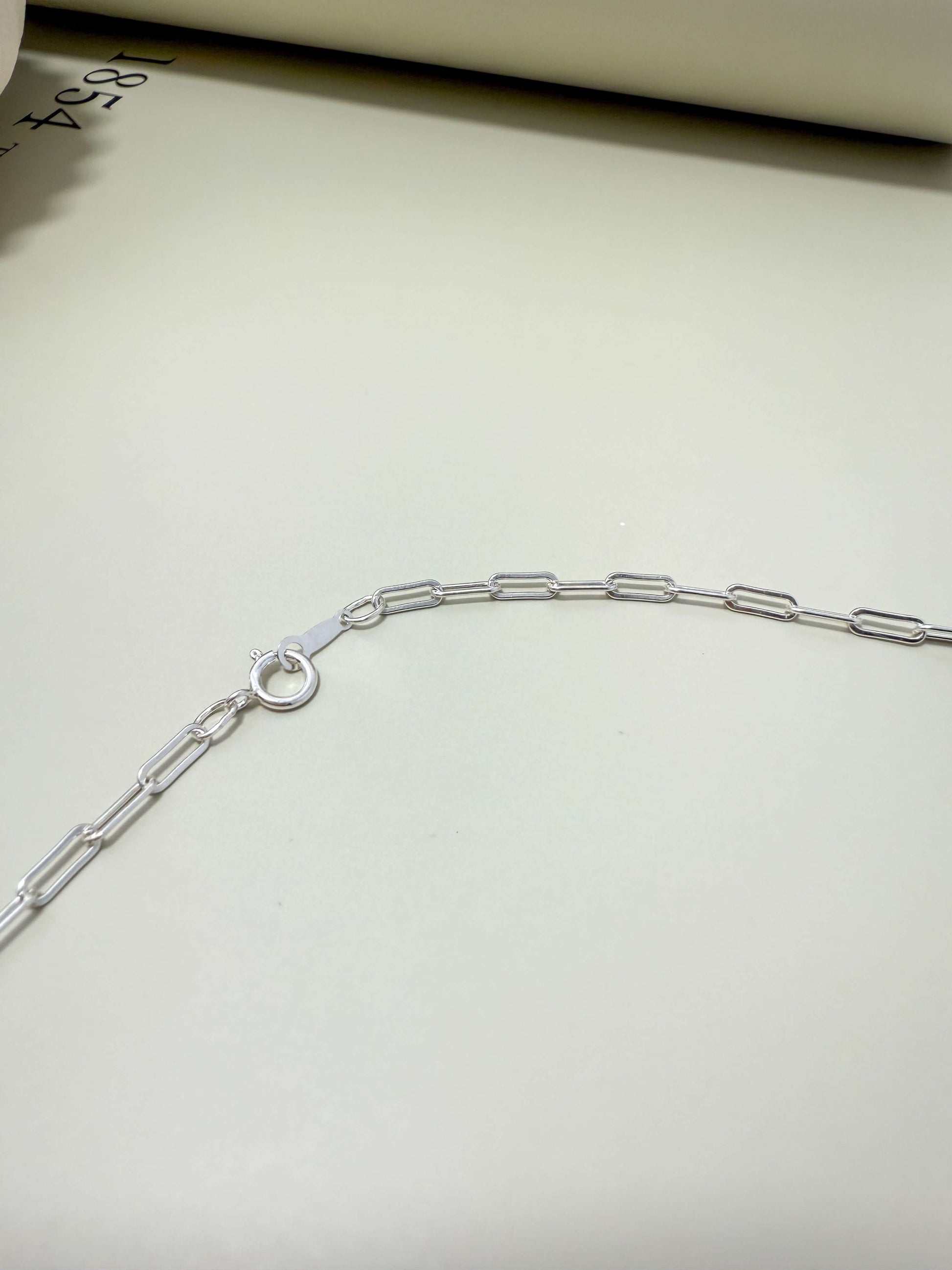 Sterling silver flat paperclip chain by Velani Jewelry. Hypoallergenic, waterproof, tarnish resistant for everyday wear.