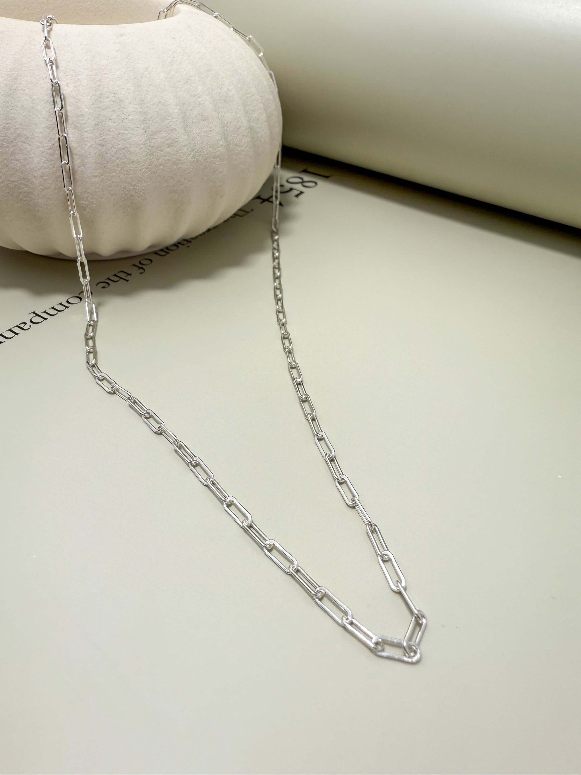 Sterling silver flat paperclip chain necklace, hypoallergenic, waterproof, tarnish resistant, ideal for everyday wear.