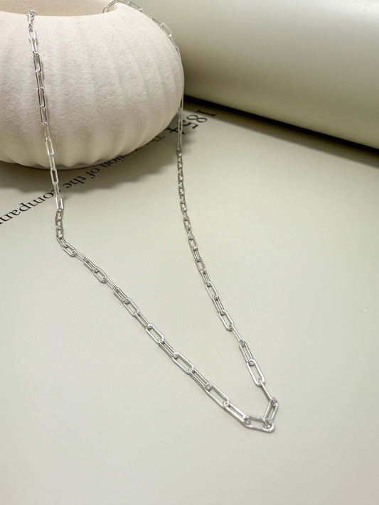 Sterling silver flat paperclip chain necklace, hypoallergenic, waterproof, tarnish resistant, ideal for everyday wear.
